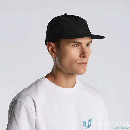Man wearing black flat-brimmed Class Linen Cap with adjustable fastener and tonal under-peak lining