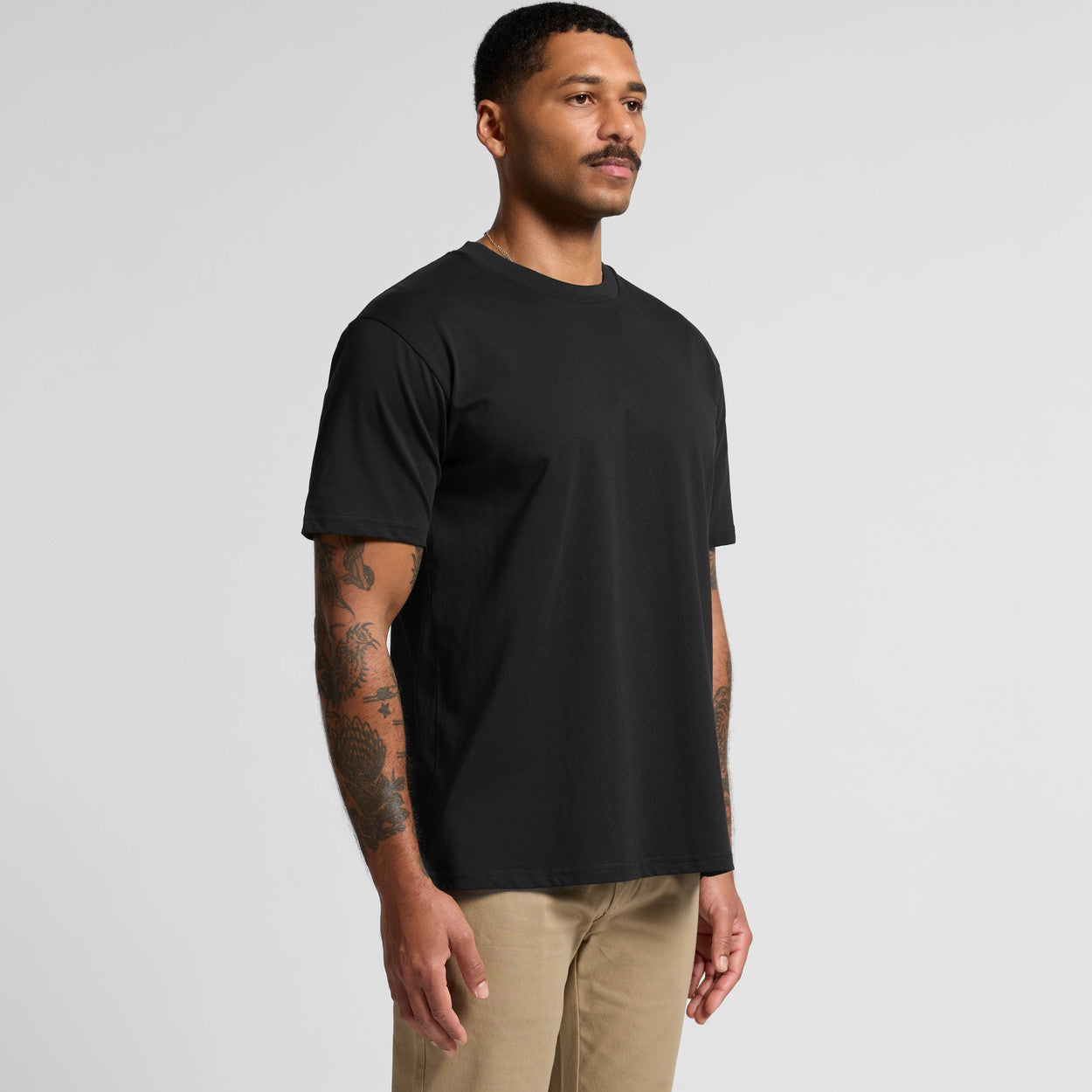 Black crew neck t-shirt with short sleeves and ribbed cuffs, made of cotton.