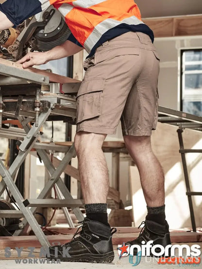 Construction worker in SYZMIK Men’s Streetworx Curved Cargo Shorts for essentials organized style