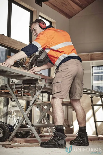 Construction worker using chop saw with SYZMIK Men’s Streetworx Curved Cargo Shorts