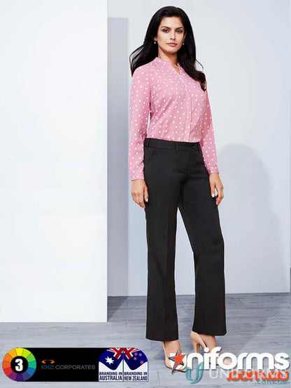 Woman wearing pink polka dot blouse with cool stretch mid rise adjustable waist pant