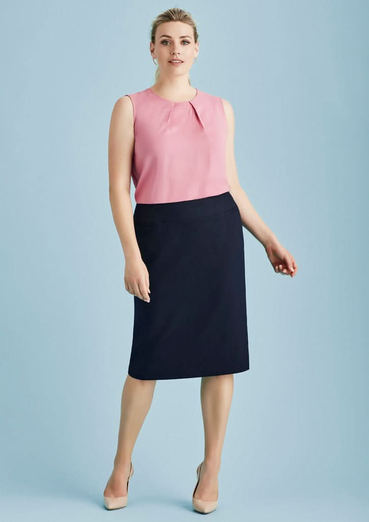 Woman wearing a pink sleeveless top with a cool stretch relaxed fit lined skirt