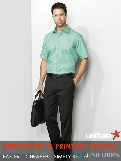 Man wearing cool stretch slimline pant in green shirt and black pants for men’s cool stretch