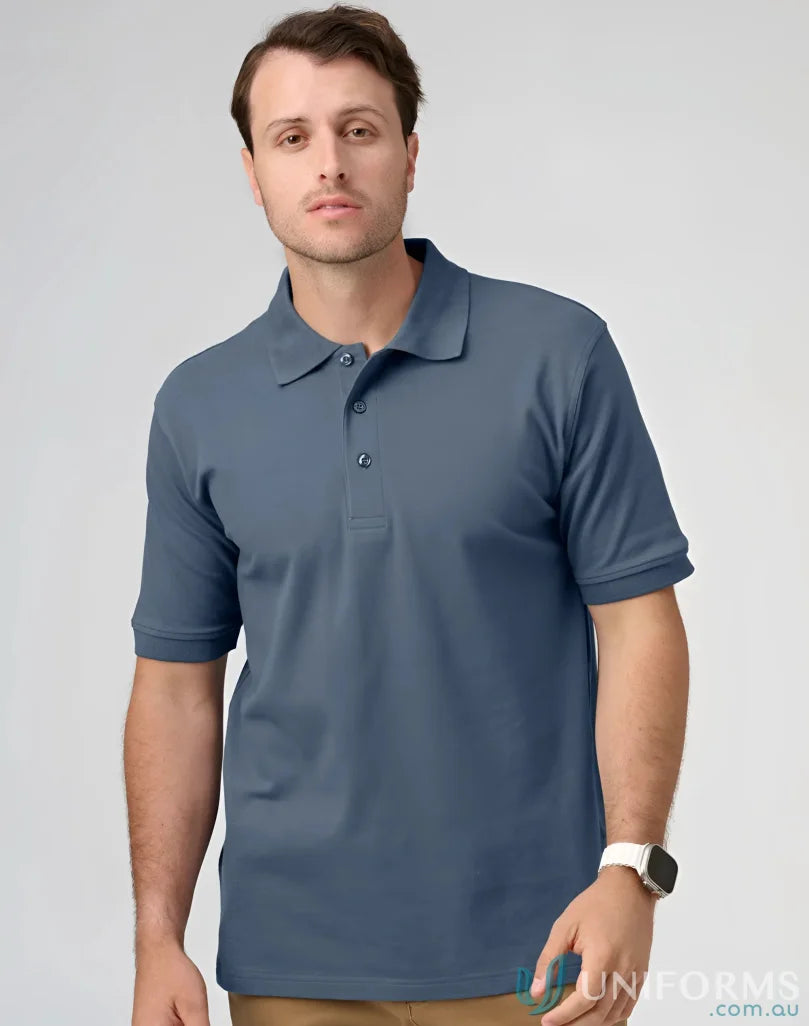 Man in a blue pique polo shirt at PS55 Darling Harbour displaying the Darling Harbour Polo