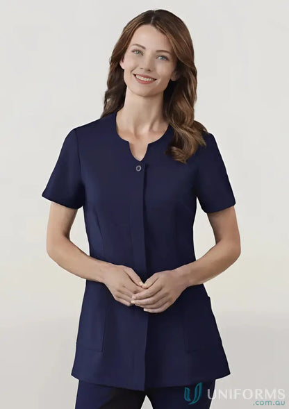 Woman modeling navy blue Eden Tunic, perfect for medical uniforms and stylish uniforms