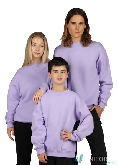 Three people wearing matching light purple sloppy joe uniforms and black workwear
