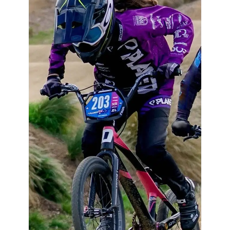 Purple and black mountain bike with number plate 203 paired with custom av8 ride pant ideal for workwear uniforms