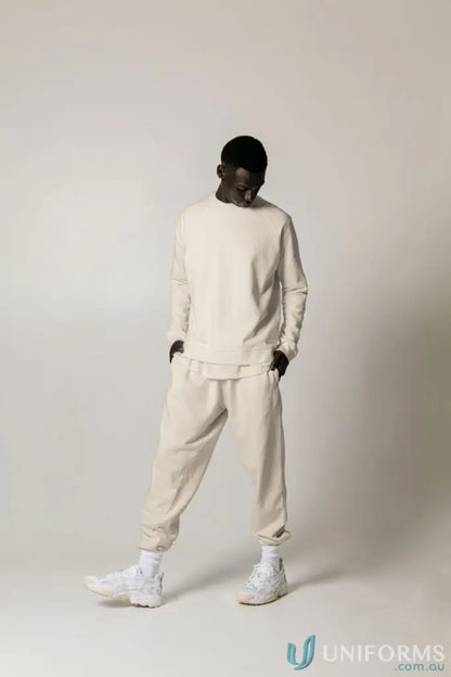 Man in matching beige Archie Crew Sweat and sweatpants showing the Archie Crew Sweat