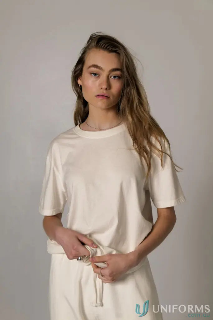 Woman in cream Bobby Tee PFD with regular fit and nameless CB embroidery