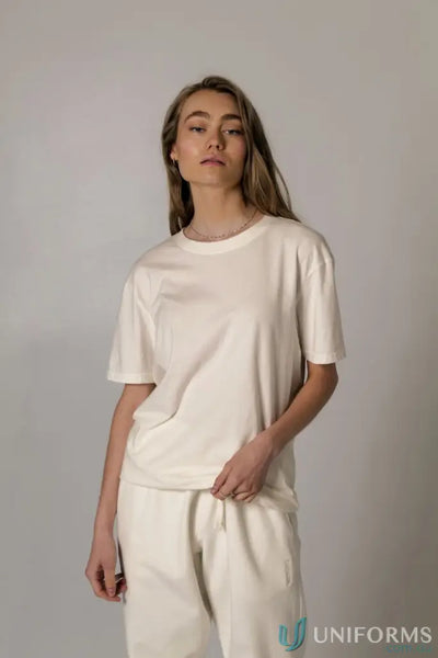 Woman wearing a cream Bobby Tee PFD with regular fit and nameless CB embroidery