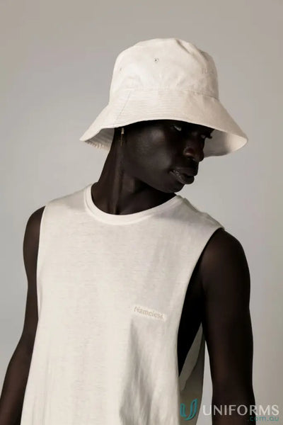 White bucket hat and sleeveless Cotton Tank Top with raw cut sleeve and nameless chest embroidery