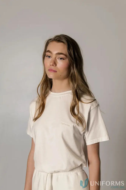 Woman wearing a Retro Fit Donald Tee with higher ribbed neckline and matching white bottoms