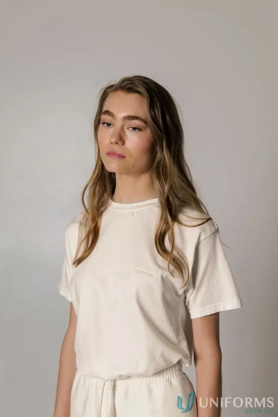 Woman wearing a Retro Fit Donald Tee with higher ribbed neckline and matching white bottoms