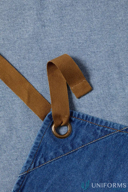 Workcraft denim bib apron with patch pocket, brown strap, and metal eyelet for café crews