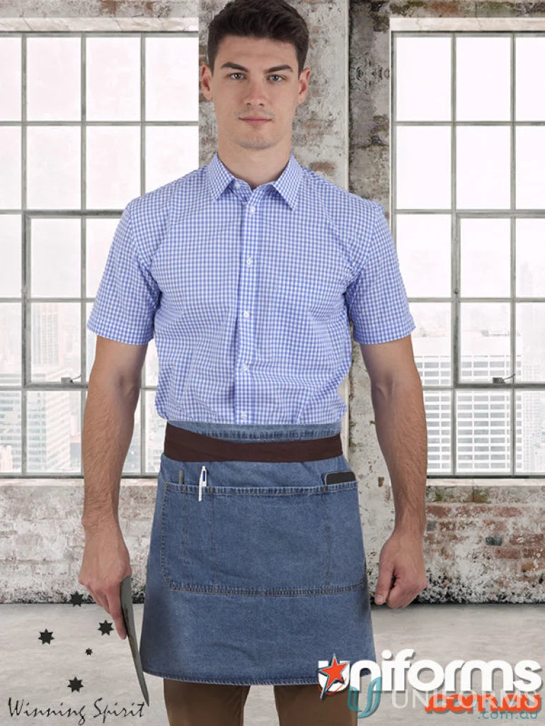 Male model wearing East Village Half denim apron and light blue checkered shirt