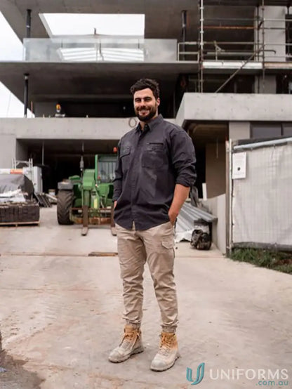 Man in Flx & Move Utility Work Shirt with active fit and beige work pants