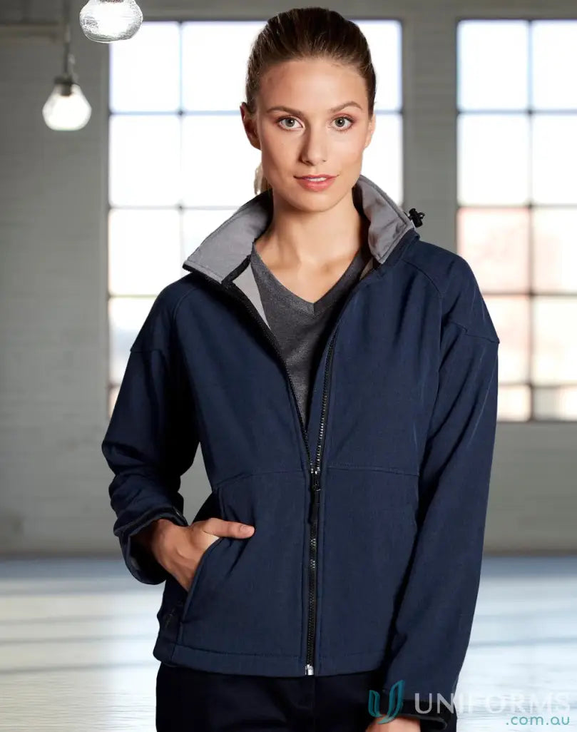 Woman wearing navy aspen softshell hooded jacket from Heart Foundation EMBx2 with hi-tech 4-way stretch