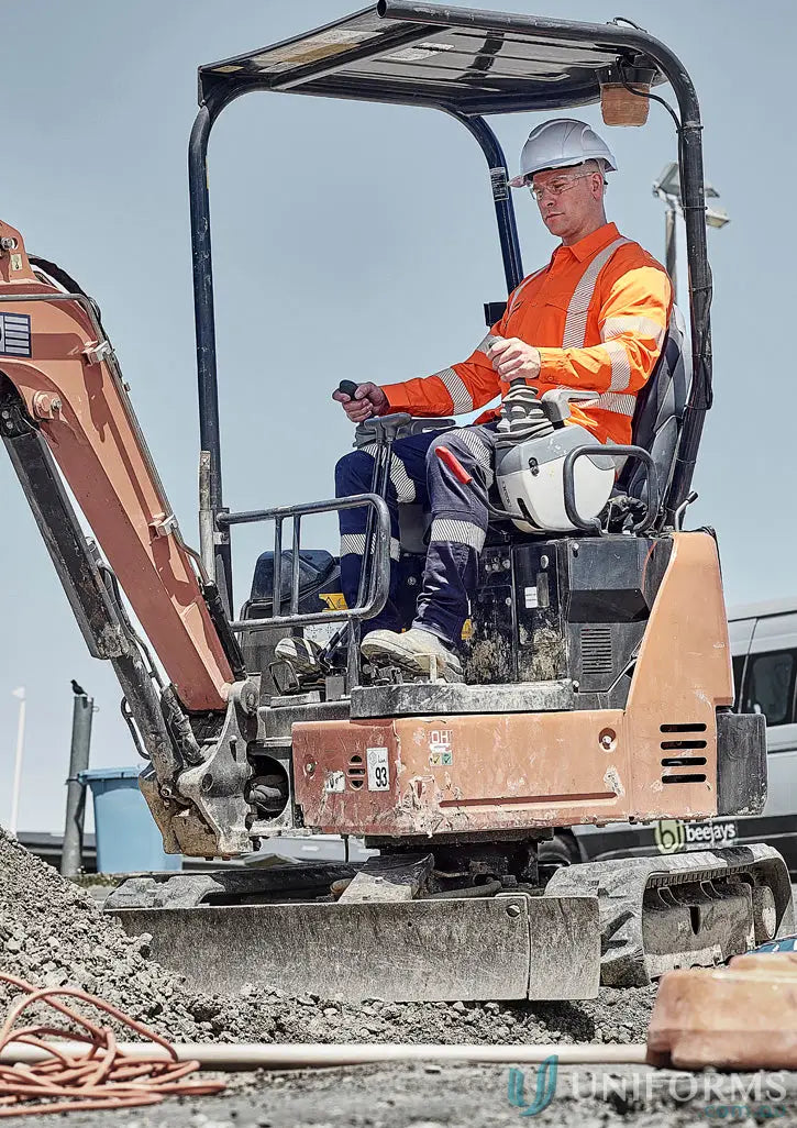 Orange mini excavator with operator for nsw rail work wearing segmented tape and reflective tape
