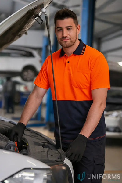 Man in HiVis Lightweight SS Polo and work gear fixing a car engine side view