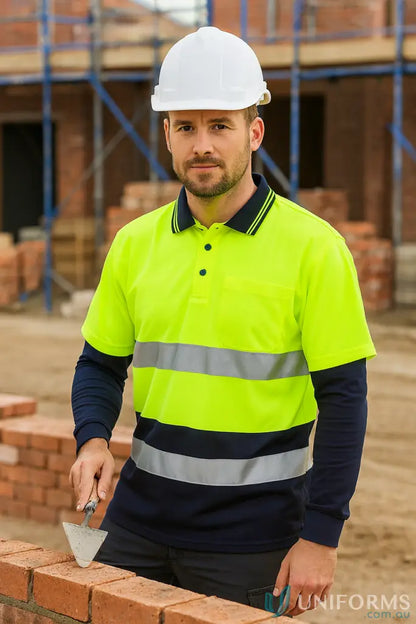 Man in white hard hat and HiVis LS cotton workwear polo holding a trowel