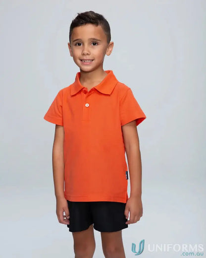 Young boy in orange Hunter Kids Polo shirt, perfect for school uniform or youth polo