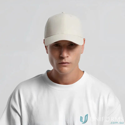 Man wearing icon nylon cap with curved peak and tonal under-peak lining in white