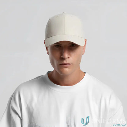 Man wearing icon nylon cap with curved peak and tonal under-peak lining in white