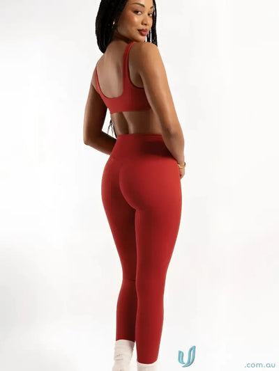 Red athletic set featuring Invisible Scrunch Cherry Leggings for workout and uniforms