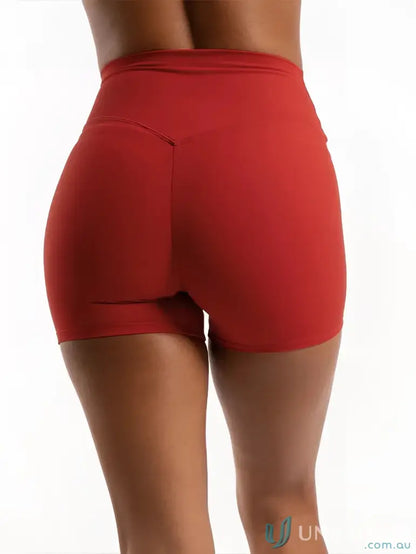 Red athletic shorts from Invicible Scrunch Cherry Shorts for workout and uniforms