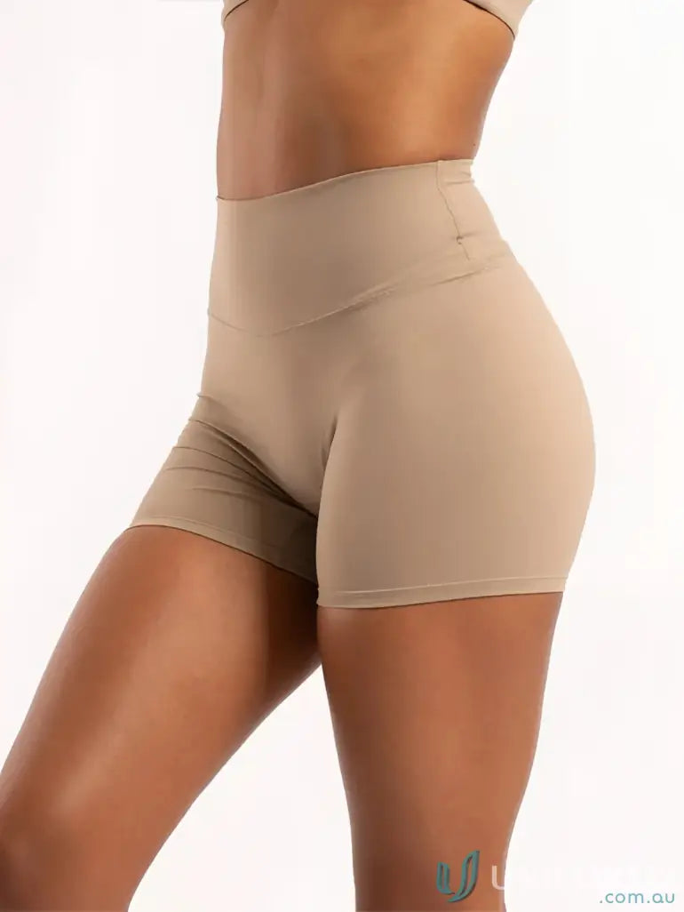 Tan high-waisted athletic shorts from Invicible Scrunch Latte Shorts with invisible scrunch style