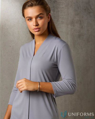 Lady with light brown hair in Ladies Isabel Stretch Knit Top and silver bracelet