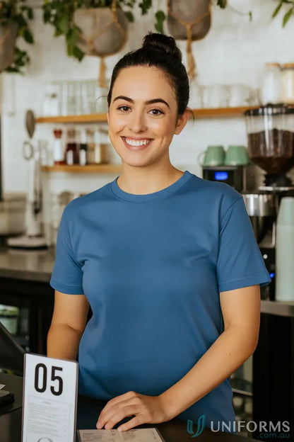 Smiling woman in a JB’s Adult 1HT Blue Tee with crew neck and classic fit