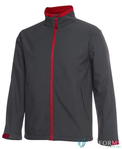 Gray softshell jacket with red trim and zip puller, stay dry in JBs Adults Water Resistant Softshell Jacket