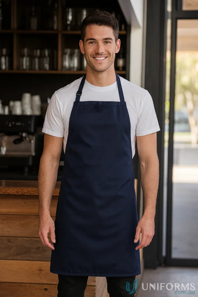 Smiling man wearing JB’s Bib Apron Without Pocket 65X71 as a work uniform