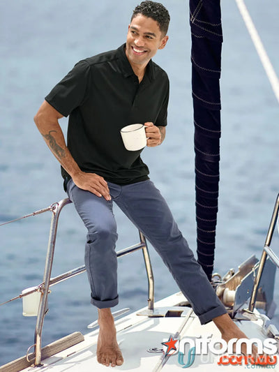 Man in black polo and blue Jean Style Flexi Chino Pants with jacquard weave