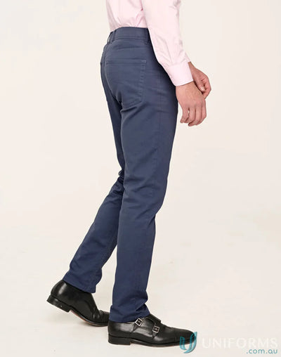 Man wearing jean style flexi chino pants with jacquard weave in blue trousers and black shoes