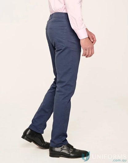 Man wearing jean style flexi chino pants with jacquard weave in blue trousers and black shoes