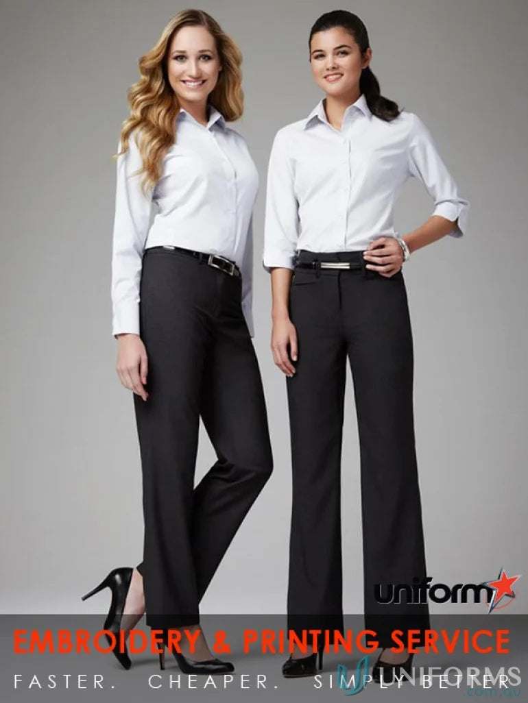 Two women in white shirts and black pants wearing JHS Ladies Relaxed Fit Pant for work uniforms