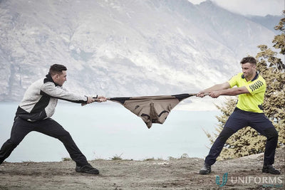 Two men stretching JHS Mens Tough Pant showing durable pants with reinforced pocket and secure waist