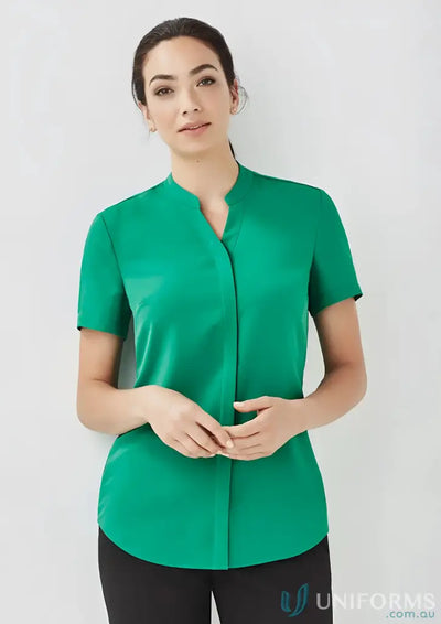 Woman wearing stylish green Juliette SS Blouse RB977LS, perfect for stylish uniforms