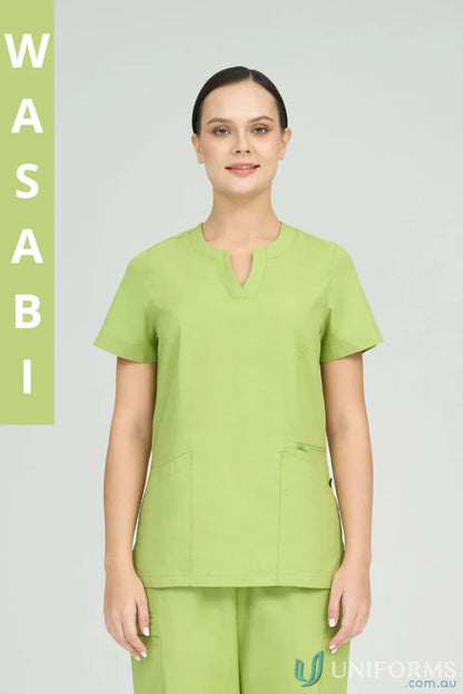 Lady modeling Ladies Amelia Scrub Top with princess seams and zip pocket in light green