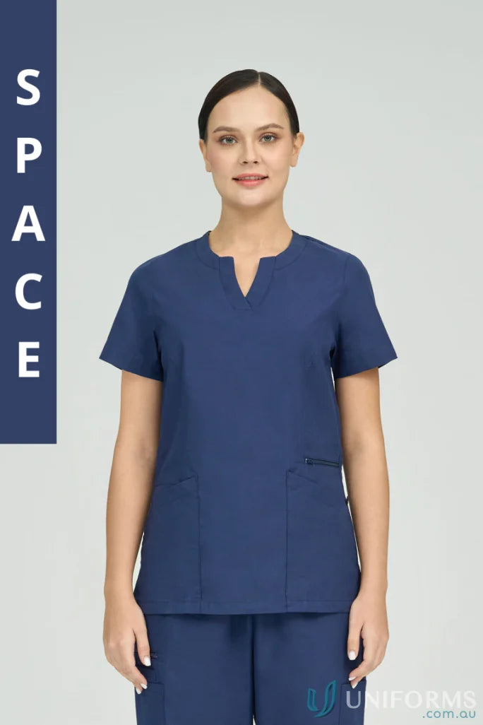 Woman in navy Ladies Amelia Scrub Top with princess seams and zip pocket