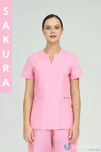 Woman in pink Ladies Amelia Scrub Top with princess seams and zip pocket