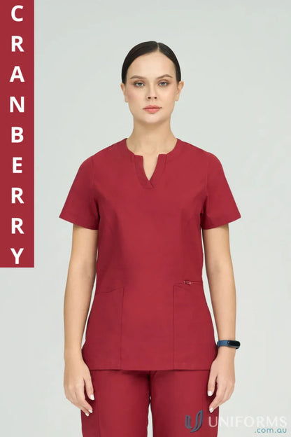 Lady in cranberry Amelia Scrub Top with princess seams and zip pocket for comfy style