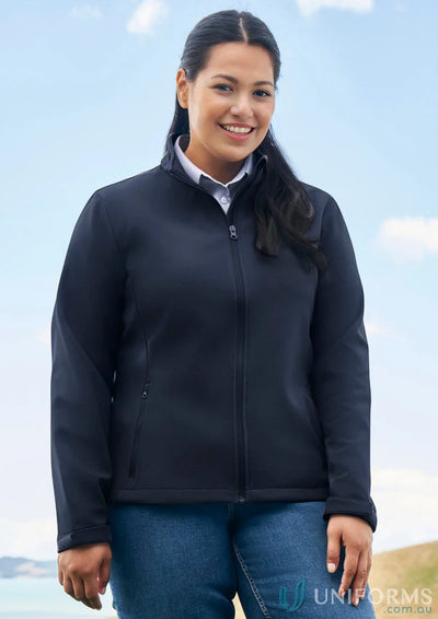Woman in navy ladies Apex Softshell Jacket, perfect for biz collection womens style