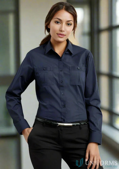 Woman wearing Ladies Bondi Roll Up LS Shirt in navy with black pants for a casual look