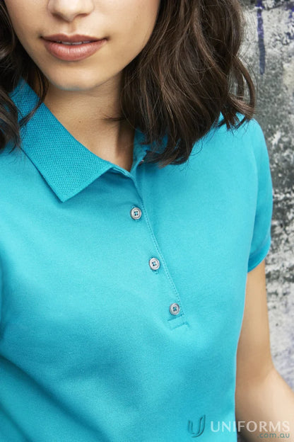 Lady wearing turquoise Ladies City City Polo short sleeve polo shirt with gray buttons