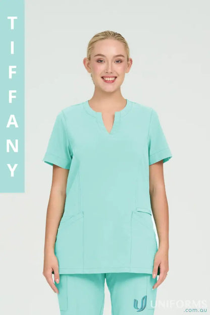 Woman wearing light blue Ladies Ellen Scrub Top perfect for suit hospital nurses or aged care staff