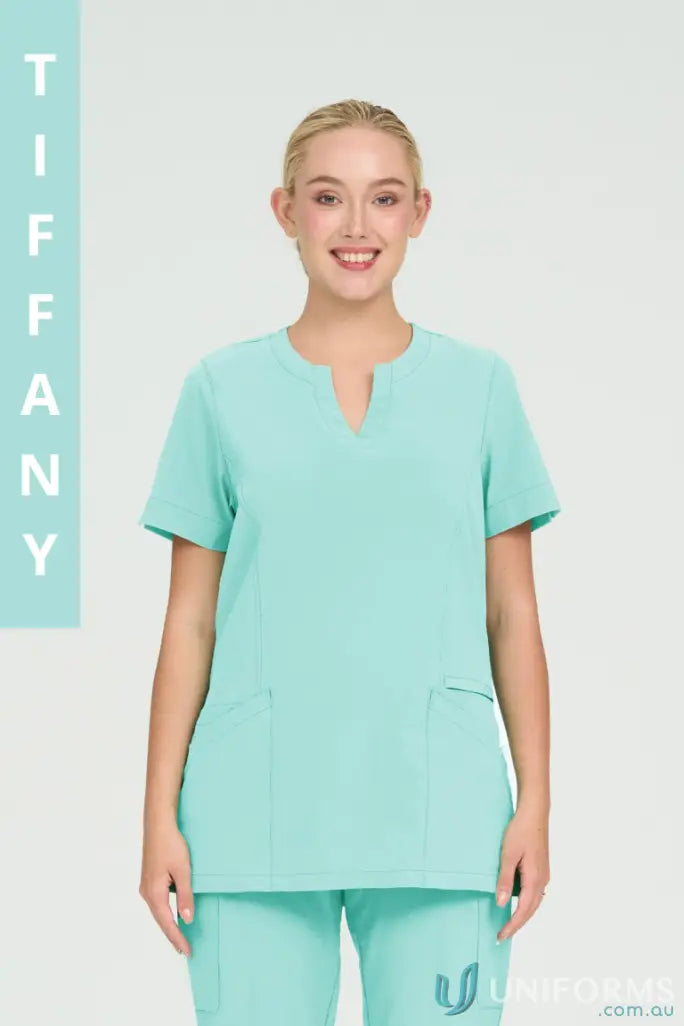Woman wearing light blue Ladies Ellen Scrub Top perfect for suit hospital nurses or aged care staff