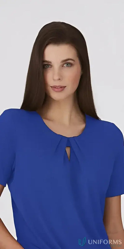 Woman in royal blue keyhole knit top with crepe texture, perfect for uniforms